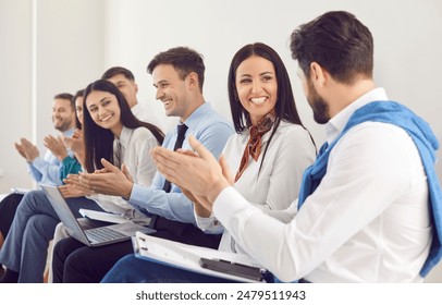 Business team celebrating success, applauding during an office meeting, presentation, or event. People crowd reflects the team unity and enthusiasm, highlighting collective achievements and teamwork. - Powered by Shutterstock