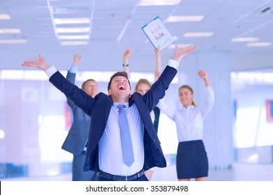 Business team celebrating a triumph with arms up 