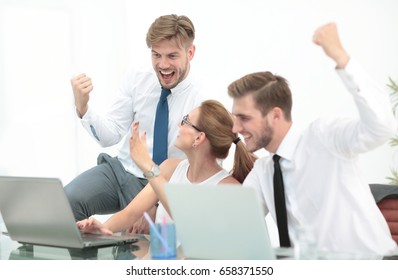 Business Team Celebrating A Triumph With Arms Up