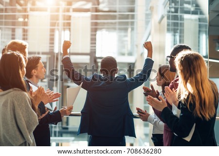 Business team celebrating a triumph with arms up