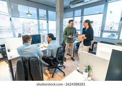 Business team collaborating on project in modern office, showcasing diversity and inclusion with wheelchair user