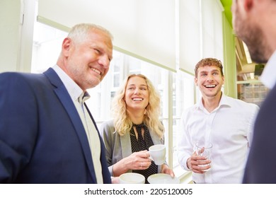 Business Team Colleagues In The Office Have Fun During A Coffee Break While Small Talk