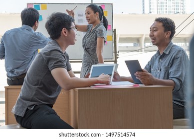 Business Team Consultations And Meetings. Holding A Summary Of Sales And Operations Of The Company In Hand. At The Meeting, The Company's Operations.