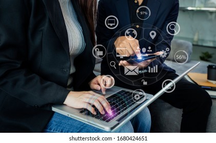 Business Team Corporate Marketing Working Concept. Business partners using laptop and digital tablet with virtual interface icons network diagram.
