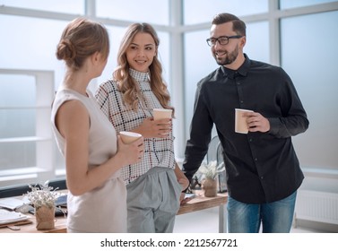 business team discussing something standing in the office