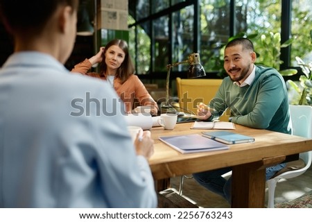 Business team discussing startup project ideas on meeting in coworking space