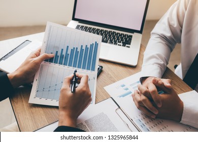 Business Team Discussion About Finance Cost Company Working Together And Pointing Paper Summary Graph.