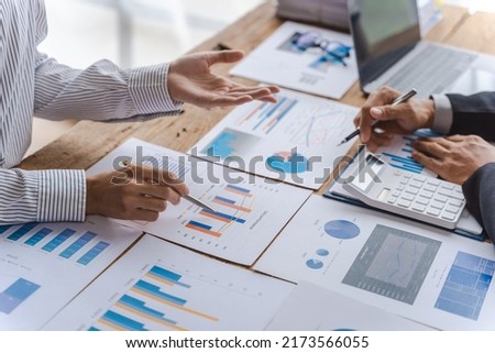 Business team of employees meeting, analyzing project document text, reports, marketing charts with sticky notes, planning work process, discussing papers, doing paperwork research. Close up of hands