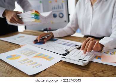 Business Team Finance Or Bookkeeper Working With A Calculator To Calculate Business Data Summary Report, Accountancy Document And Laptop Computer At The Office, Business Meeting Concept