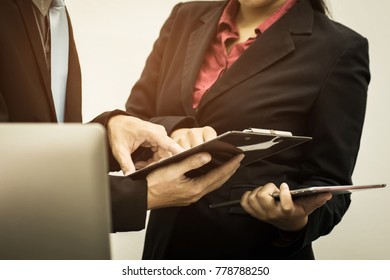 Business team financial inspector and secretary making report, calculating or checking balance, Audit concept at working with plan and analyzing investment charts at his workplace. - Shutterstock ID 778788250