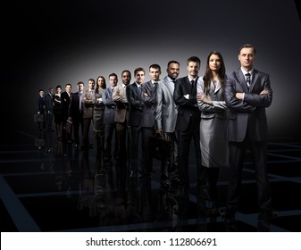 business team formed of young businessmen standing over a dark background