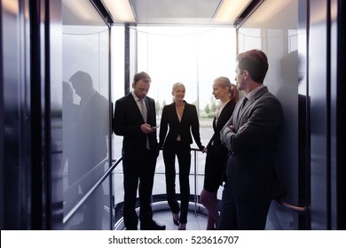 Business Team Going On Elevator And Talking