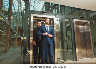 Business Team Going On Elevator And Talking