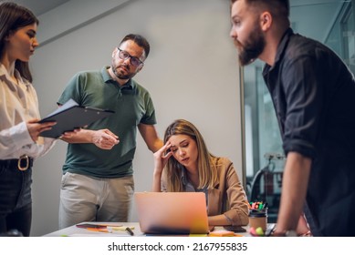 Business team having a meeting in the office and solving a problem. Teamwork, people and crisis concept. Depressed by failure, bad news, feeling desperate about company bankruptcy or financial crisis. - Powered by Shutterstock