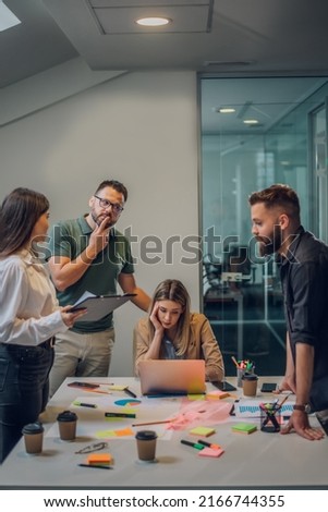 Business team having a meeting in the office and solving a problem. Teamwork, people and crisis concept. Depressed by failure, bad news, feeling desperate about company bankruptcy or financial crisis.
