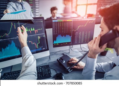 Business team investment trading do this deal on a stock exchange. People working in the office. - Shutterstock ID 707850085