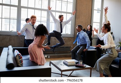 Business Team Jump For Joy At Hitting Target In Meeting