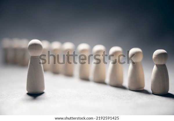 Business team leadership with\
one person standing out from the crowd with motivation speech\
concept