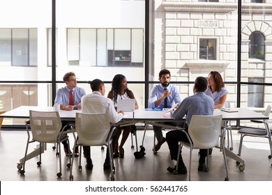 Business Team Look To Manager At Meeting In Open Plan Office