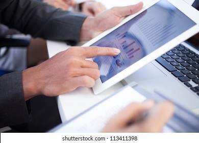 Business team meeting to discuss statistical data presented in the form of digital graphs and charts - Powered by Shutterstock