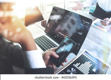 Business team meeting. Photo professional investor working new start up project. Finance task.Digital tablet laptop computer smart phone using, Sun flare effect                                - Shutterstock ID 443536393