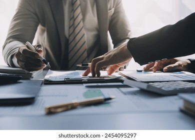 Business team meeting present, investor colleagues consultation and conference new strategy plan business and market growth on financial document graph report, Meeting and Talking. - Powered by Shutterstock