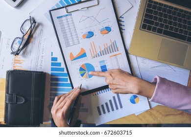 Business Team Meeting Working With New Startup Project, Discussion And Analysis Data The Charts And Graphs. Digital Tablet Calculator, Laptop Computer Using, Business Finances And Accounting Concept.