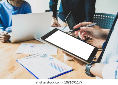 Business team meeting working on digital tablet, point to discuss the graph up and down of economy .Selective Focus - Shutterstock ID 1091691179