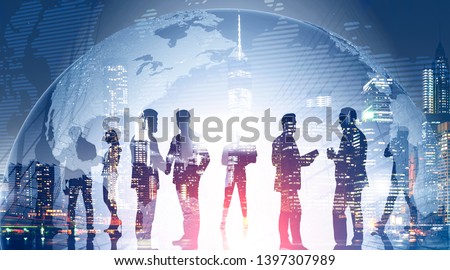 Business team members standing over night city background with double exposure of planet. Concept of international company and globalization. Toned image. Elements of this image furnished by NASA