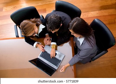 Business Team In An Office Laptop Computer - Meeting Taken From The Top At A Very High Angle