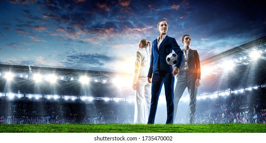 Business Team On Football Stadium. Mixed Media