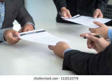 Business Team partners reading a document before signing contract agreement was signed co-investment business.business managers team working with new startup project in office room. Selective focus. - Shutterstock ID 1110115778