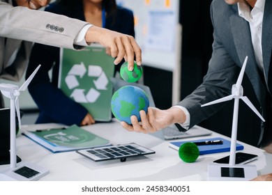 business team people planning and discussing on recycle reduce reuse policy symbol in office meeting room. Green business company and Solar Energy Environment city Concept. - Powered by Shutterstock