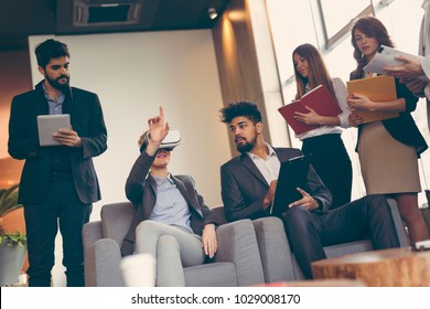 Business team presenting new project to a client on a virtual reality simulator. Focus on the people sitting - Powered by Shutterstock