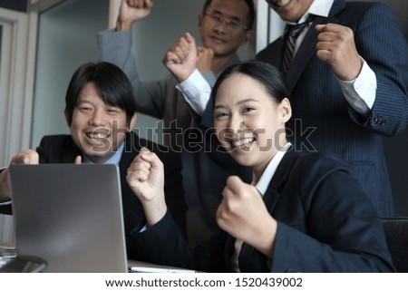business team raise hands with happiness for successful project. cheerful asian businessman & businesswoman showing gladness for achievement