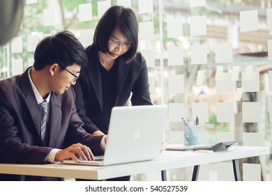 Business Team Sales Persons Using A Laptop To Calculate Pie Chart And Exponential Growth Statistics On Office Desk Concept.