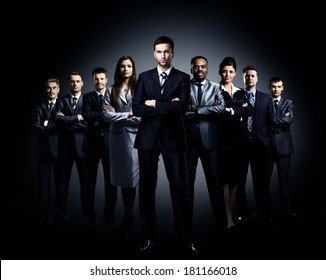 Business Team Standing Over A Dark Background