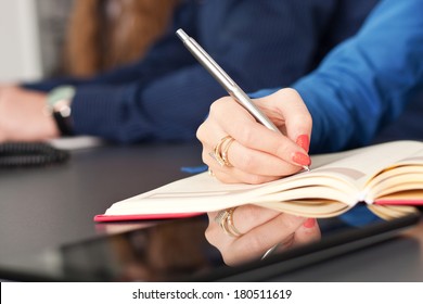 Business Team Taking Notes On A Meeting