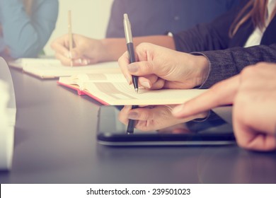 Business Team Taking Notes On A Meeting 