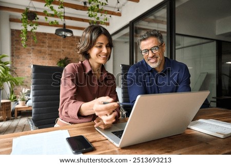 Similar – Image, Stock Photo Work colleagues in a tailor shop, one in focus, share a moment in a sewing workspace. They’re surrounded by colorful threads, with one holding a spool of red thread