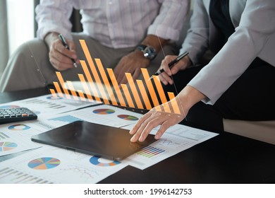 business team using laptop computer with financial report spreadsheet virtual screen interface for business and marketing research evaluation performance. - Shutterstock ID 1996142753