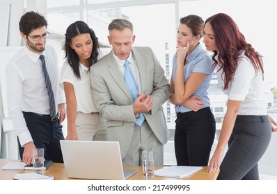 Business team using a laptop in a meetiing