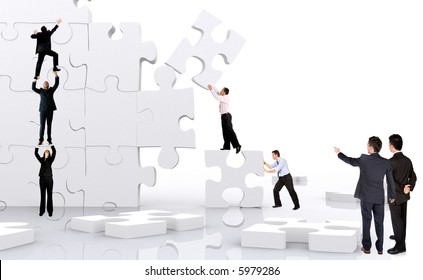 Business Team Work Building A Puzzle Isolated Over A White Background