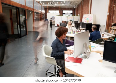 Business Team Working At Desks In Modern Open Plan Office