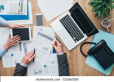 Business team working at office desk and analyzing financial reports, finance and accounting concept, top view - Shutterstock ID 521063305