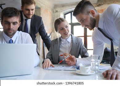 business team working on laptop to check the results of their work. - Shutterstock ID 1396741805