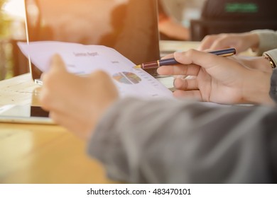 Business team working on laptop, while sitting at office. Business people. - Shutterstock ID 483470101