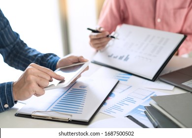 Business team working with plan on office desk with new startup project analyzing financial document data charts and graphs in Meeting and successful teamwork Concept