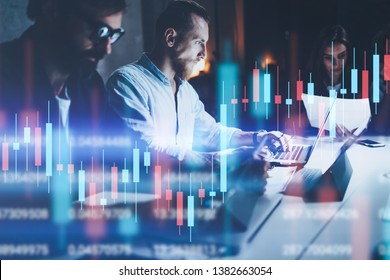 Business team working together at night office.Technical price graph and indicator, red and green candlestick chart and stock trading computer screen background. Double exposure. - Powered by Shutterstock