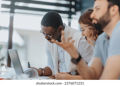 Business team working together on marketing strategies in a modern office space. Analyzing data, planning campaigns, and targeting specific audiences for successful advertising and lead generation. - Powered by Shutterstock